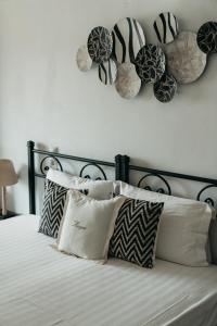 a bed with pillows and hats on the wall at Astrio Suites in Livadi