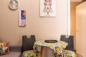 a table and two chairs in a room at La casa di Adina in Agrigento +4 photos