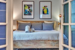 a bedroom with a wooden bed with pictures on the wall at 1920s Bungalow with King bed WIFI Fenced backyard in Atlanta