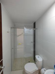 a bathroom with a toilet and a glass shower at Edificio Verona 57 - Apartamento en Piedecuesta in Piedecuesta
