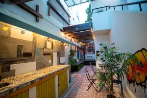 a room with a counter and some plants in a building at Tapia Haus 103 - San Juan, Beach Vibes Walking Distance in San Juan