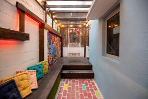 a hallway with chairs and a table in a building at Tapia Haus 103 - San Juan, Beach Vibes Walking Distance in San Juan