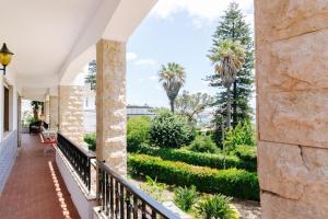 a view from the balcony of a house with palm trees at Spacious seaside house in Cascais