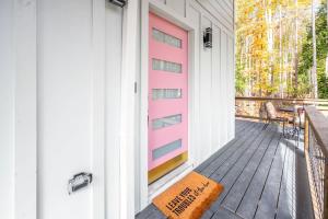 a porch with a pink door and a bench at Two Tree Houses - Galaxy & Full Bloom in Pittsboro +27 photos