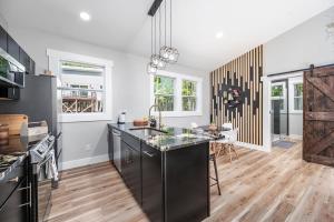 a kitchen with a large island in the middle at Elevate Tree House Community in Pittsboro