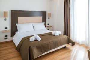 Voodi või voodid majutusasutuse NSM Hotel Palace Lucera toas