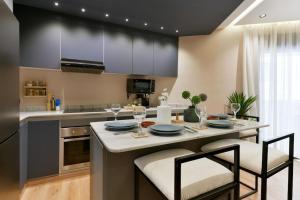 a kitchen with a large island with a table and chairs at Sky Blue Suite - Terrace & Ocean View 2BR in Tangier
