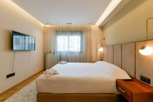 a bedroom with a large white bed and a window at Sky Blue Suite - Terrace & Ocean View 2BR in Tangier +36 photos