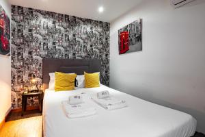 a bedroom with a bed with a black and white wallpaper at Panoramic River View Downtown With Terrace in Porto