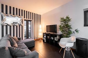 a living room with a couch and a tv at Panoramic River View Downtown With Terrace in Porto