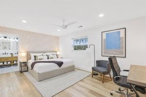 a bedroom with a bed and a desk and a chair at WP Delray Waterfront, Pool, Tiki Hut & Putting Grn in Delray Beach +65 photos