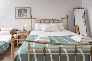 a bedroom with a large bed and a mirror at Marathitis cottage house - Aegean sea view in Kanakis