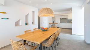 a dining room with a wooden table and chairs at Casas de Carvoeiro by Sevencollection in Carvoeiro