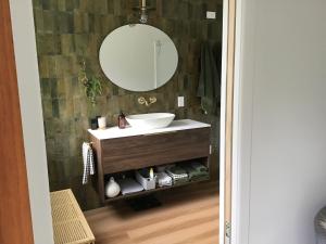 a bathroom with a sink and a mirror at Self contained and private room in Dunedin