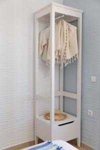 a closet with a white cabinet in a room at Apiliotis sunrise beach villa in Ligaridia +67 photos