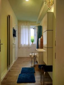 a bathroom with a sink and a toilet and a window at Ferienwohnung am Ellerbach in Hessisch Oldendorf
