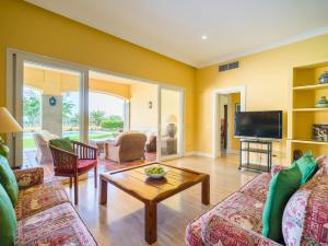 a living room with a couch and a tv at Golf Views Home By CanariasGetaway in Maspalomas