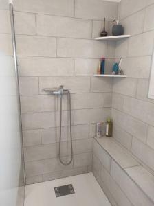 a bathroom with a shower with a glass door at Maison au milieu des vignes in Vacqueyras