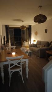 a living room with a table and a couch at L'AUNISA in El Campello +22 photos