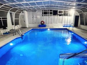 a large swimming pool with blue water at Apartamentos Laguna Beach 2 in Torrox Costa