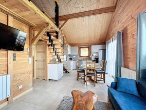 a living room with a blue couch and a table at Chalet 6 pers, WiFi, parking, proche pistes - FR-1-267-297 in Villarembert