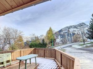a deck with a table and a mountain view at Chalet 6 pers, WiFi, parking, proche pistes - FR-1-267-297 in Villarembert