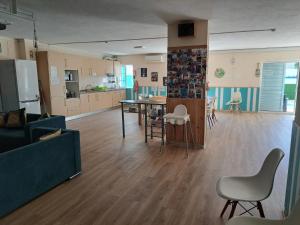 a living room with a kitchen and a table and chairs at My Guest House in Portimão