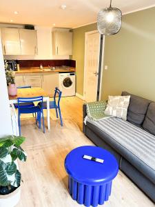 a living room with a couch and a table at GRANBY APARTMENTS F-2 in Leicester
