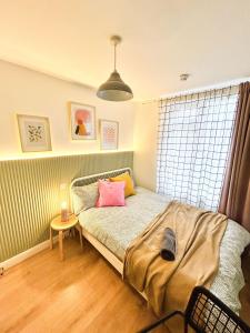a bedroom with a bed with two pillows on it at GRANBY APARTMENTS F-2 in Leicester