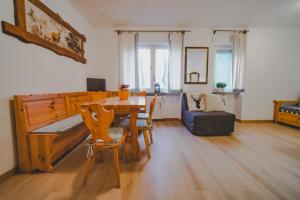 a living room with a table and a couch at Magic Ski a Bardonecchia in Bardonecchia