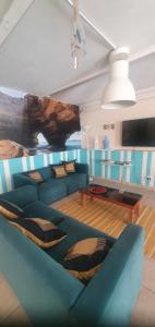 a living room with a blue couch and a table at My Guest House in Portimão