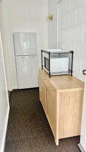 a kitchen with a refrigerator and a wooden counter at House of Somer in Matamata