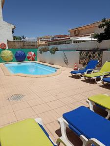 a patio with chairs and a swimming pool at My Guest House in Portimão