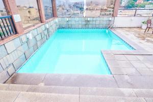 a blue swimming pool on top of a building at South American Copacabana Hotel in Rio de Janeiro