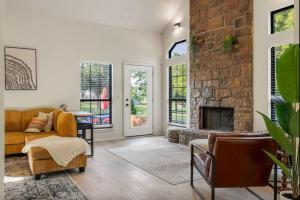 a living room with a couch and a fireplace at Turkey Mountian Trailside By Tulsa Getaways in Tulsa