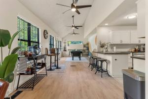 a kitchen with white cabinets and a table and chairs at Turkey Mountian Trailside By Tulsa Getaways in Tulsa
