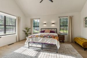 a bedroom with a bed and two windows at Turkey Mountian Trailside By Tulsa Getaways in Tulsa