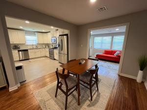 a kitchen and living room with a table and chairs at Rt 66 Fairgrounds Retreat By Tulsa Getaways in Tulsa