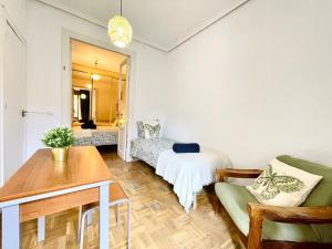 a living room with a couch and a table at Centric Rooms Madera Gran Via in Madrid