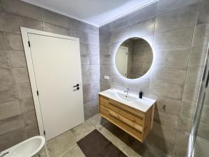 a bathroom with a sink and a mirror at Sweet Home Cascais in Cascais
