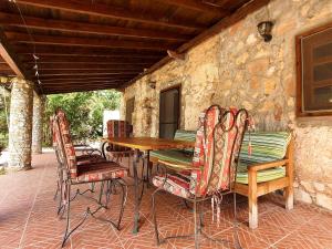 a wooden table and chairs on a patio at Stone house in Faralya in Fethiye