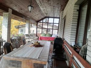 an outdoor patio with a table and chairs at Vila Seoska idila in Izvor