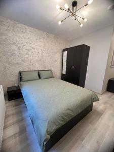a bedroom with a bed and a ceiling fan at Apartament Marieva 1 in Craiova