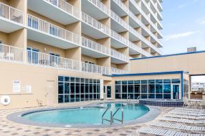an image of the pool in front of a hotel at Crystal Tower 508 by Vacation Homes Collection in Gulf Shores