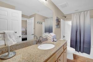 a bathroom with a sink and a toilet at Crystal Tower 508 by Vacation Homes Collection in Gulf Shores