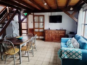 a living room with a wooden table and a blue couch at Morada de los Legui in Ushuaia