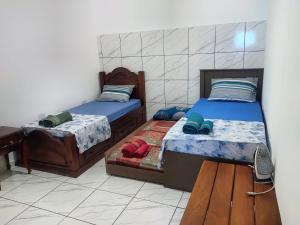 Ένα ή περισσότερα κρεβάτια σε δωμάτιο στο Aconchego da dona Dulce