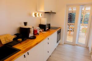 a kitchen with a counter with a coffee maker on it at Homey Luxury- entire house, free parking, yard in Cluj-Napoca