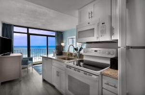 a kitchen with white appliances and a view of the ocean at Maritime Beach Club in Myrtle Beach