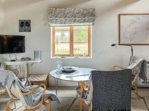 a living room with a table and chairs and a window at 6 person holiday home in Ljugarn-By Traum in Ljugarn